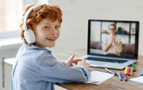 Cheerful boy during online lesson at home. photo