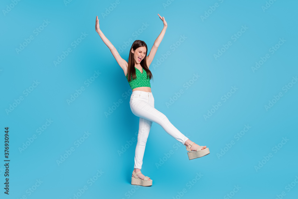 full length photo of crazy candid girl scream raise hands enjoy free time holiday wear good look clothes isolated over blue color background