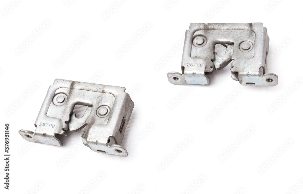 A pair of metal locks separately on a white isolated background in a photography studio, aluminum hood parts for replacement during repair or auto-parsing sale. A pair of metal locks separately on a white isolated background in a photography studio, aluminum hood parts for replacement during repair or auto-parsing sale.