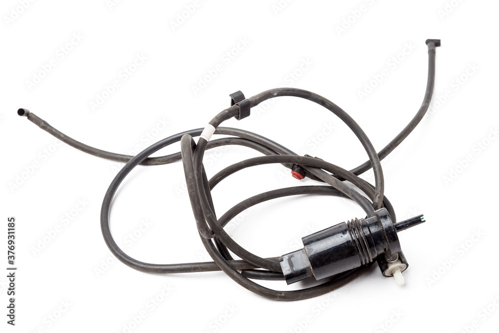 Black plastic glass washer pump reservoir with wire and hose on a white isolated background in a photo studio - for sale or replacement when repairing a car in a car service. Black plastic glass washer pump reservoir with wire and hose on a white isolated background in a photo studio - for sale or replacement when repairing a car in a car service.