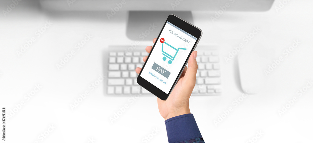 Hand holding smartphone device and touching screen. Online shopping SME entrepreneur. Buy and sell online. Mobile payment with wallet app Hand holding smartphone device and touching screen. Online shopping SME entrepreneur. Buy and sell online. Mobile payment with wallet app