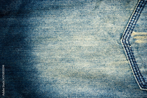 clothing items blue stonewashed faded jeans cotton fabric texture with seams, clasps, buttons and rivets, macro, close-up