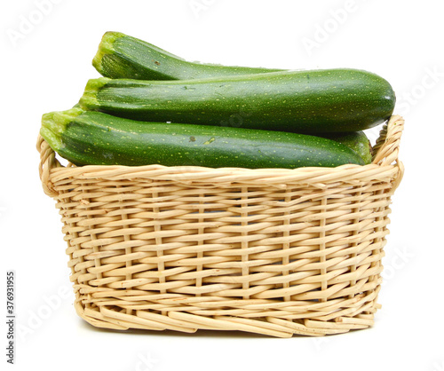 fresh zucchini's (Cucurbita pepo) in basket on a white background