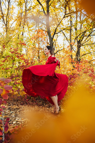 Girl spinning on a walk at nature. Happy girl enjoying autumn. Dream, carefree, freedom and happiness concept.