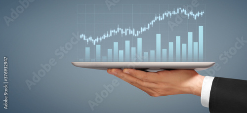 Businessman plan graph growth increase of chart positive indicators in his business, tablet in hand