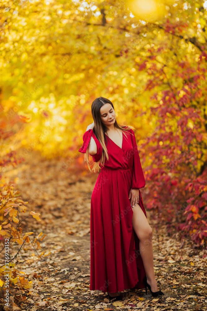 Cute girl looks happy at autumn forest.
