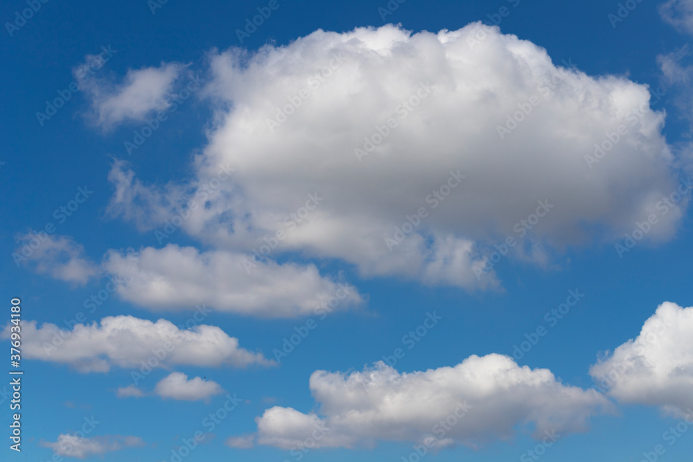 Fluffy white cloud formation in a beautiful blue sky Fluffy white cloud formation in a beautiful blue sky
