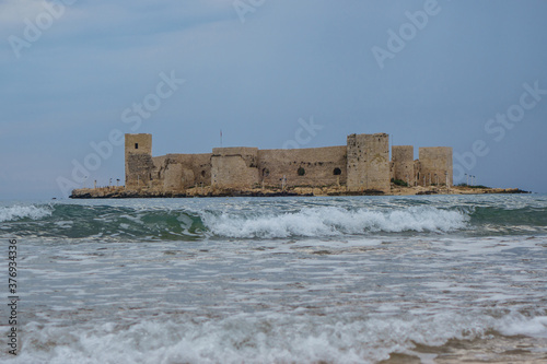 Kızkalesi, medieval castle located on small Mediterranean island. Fortress was built in 11 century by Byzantines. Now it's popular tourist sight in resort city Kizkalesi, Mersin province, Turkey photo