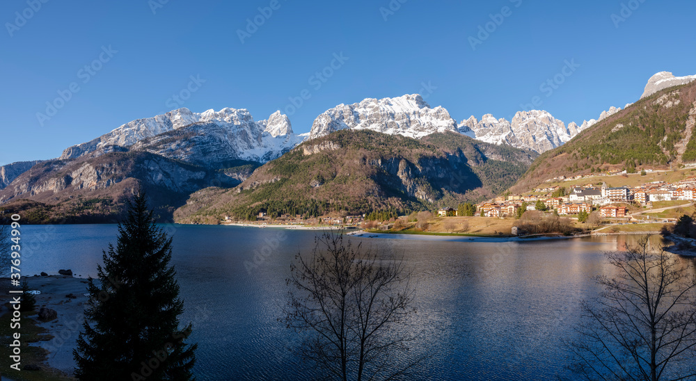 View of the city of Molveno and the snow-capped peaks of the Dolomites.