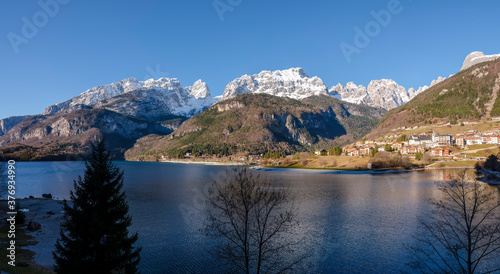 View of the city of Molveno and the snow-capped peaks of the Dolomites.