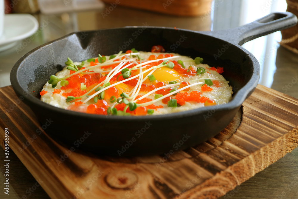 Fried eggs topped with salmon roe, shrimp roe and microgreen for Ketogenic and Paleo Diet dish Fried eggs topped with salmon roe, shrimp roe and microgreen for Ketogenic and Paleo Diet dish