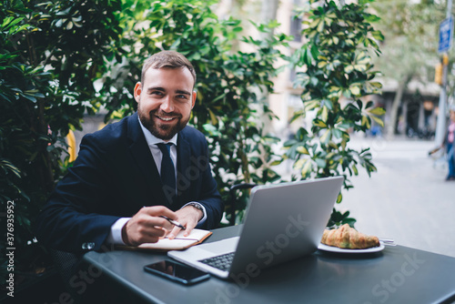 Smiling bearded young male entrepreneur during break © BullRun