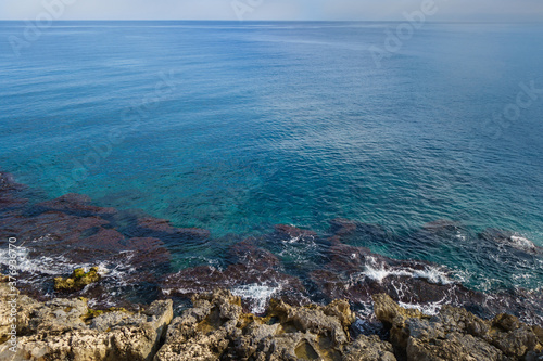 Panoramic view onto Mediterranean coastline, including underwater reefs & coastal rocks, waves washing them. Picture taken from top of medieval castle Kizkalesi, Turkey