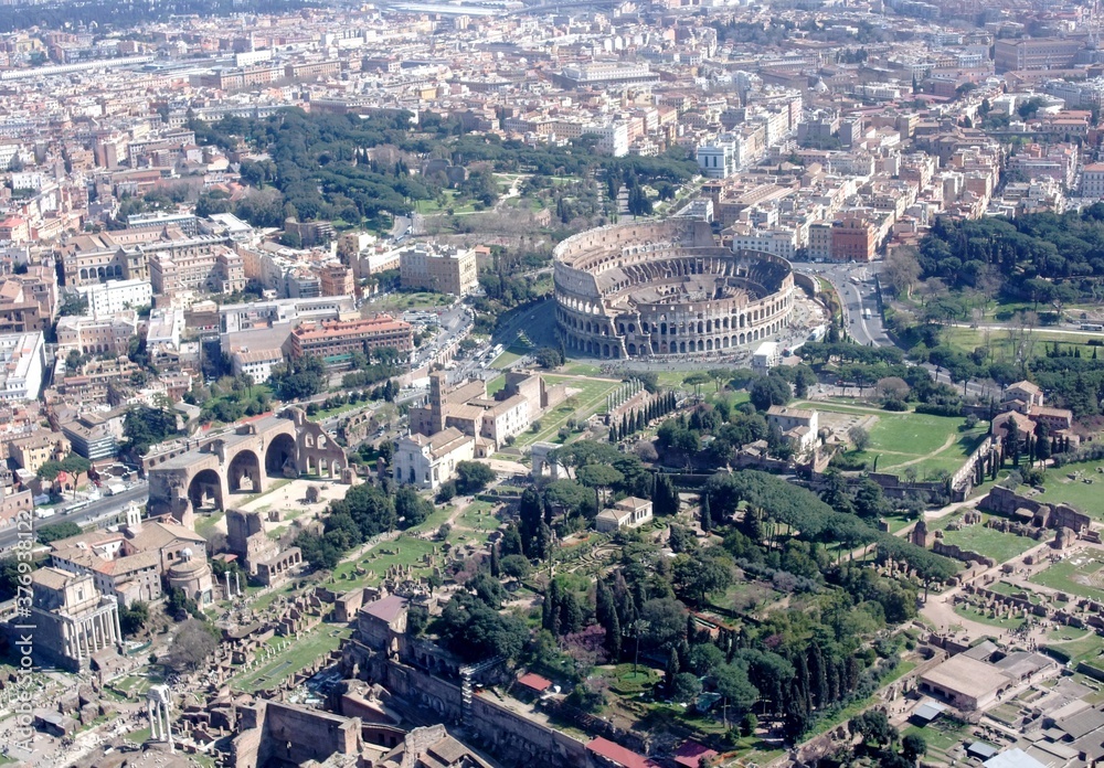  aerial view of the Colosseum in Rome with surrounding area in the background