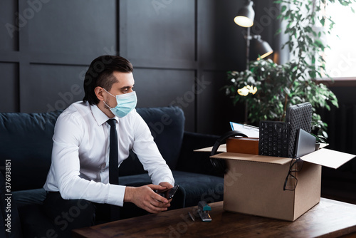 Young man getting fired from his job because of virus pandemic photo