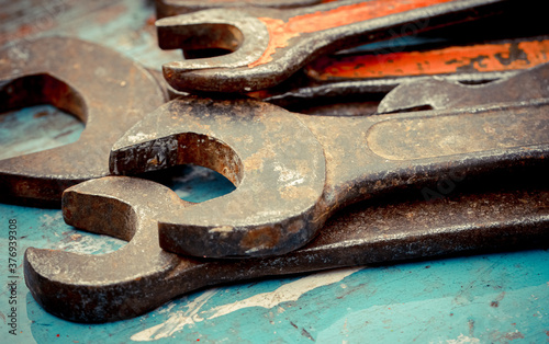 Old spanners. Grunge background of instruments. Keys close-up. Vintage turquoise and red