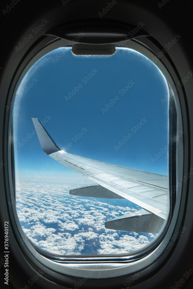 View from airplane window on wing and sky with clouds View from airplane window on wing and sky with clouds