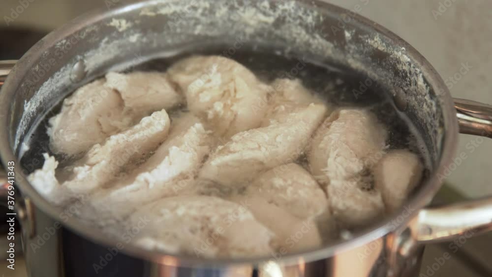 Top view of the boiling chicken breast in a pot. Top view of the boiling chicken breast in a pot.