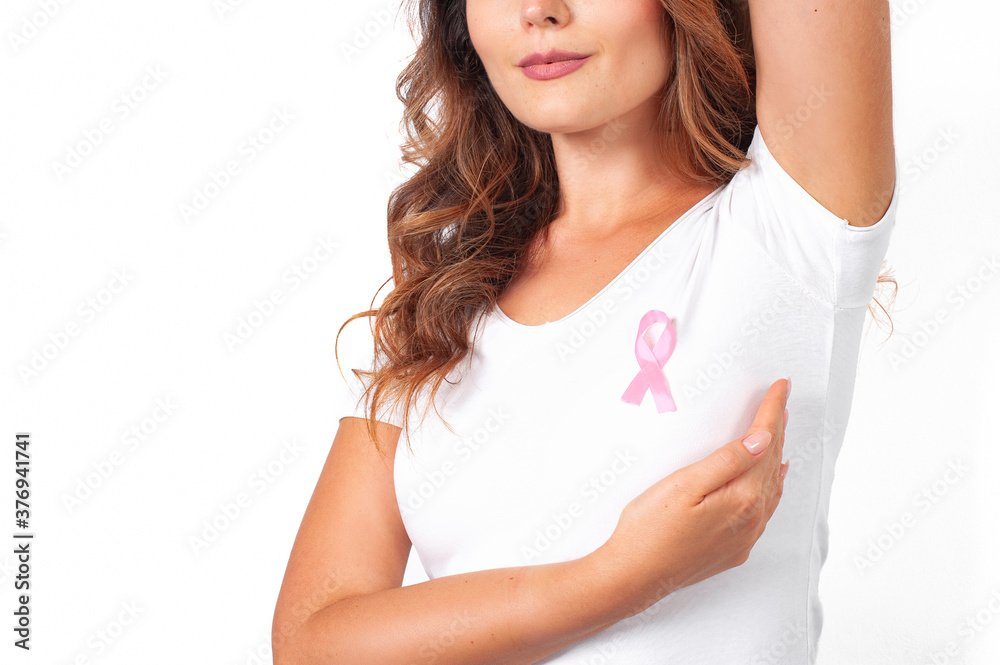 Woman in white t-shirt with pink ribbon supporting breast cancer awareness campaign