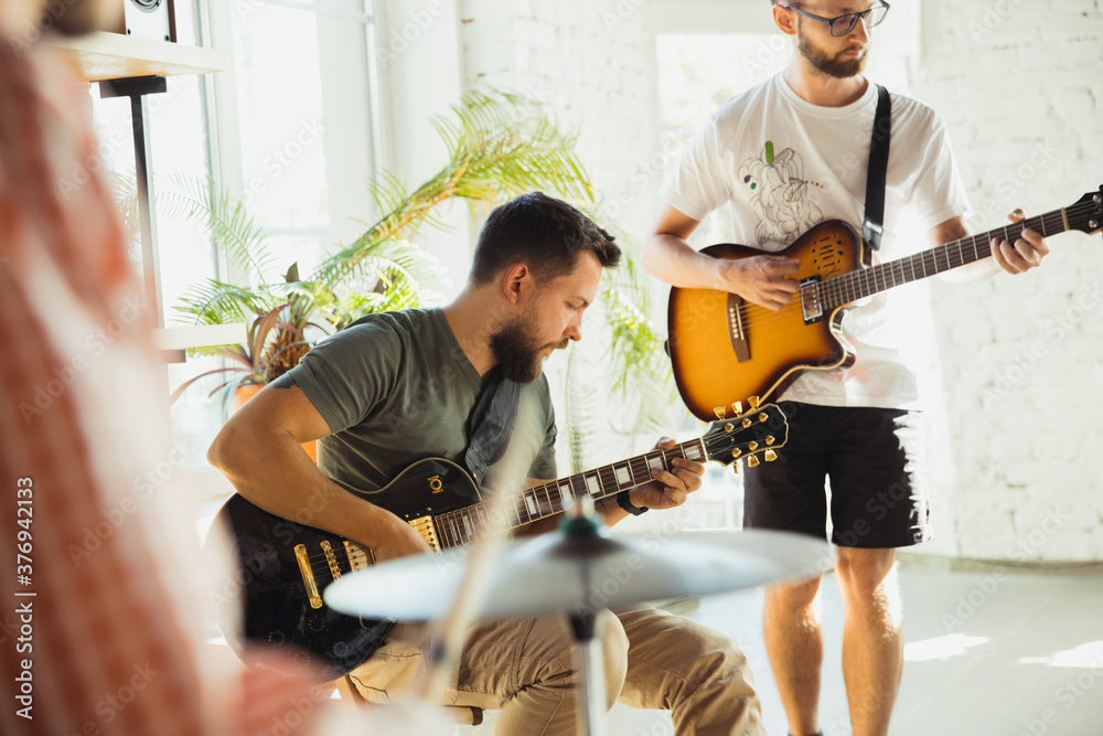 Inspiration. Musician band jamming together in art workplace with