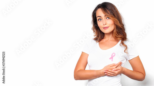 Obraz na płótnie Woman in white t-shirt with pink ribbon supporting breast cancer awareness campaign w salonie