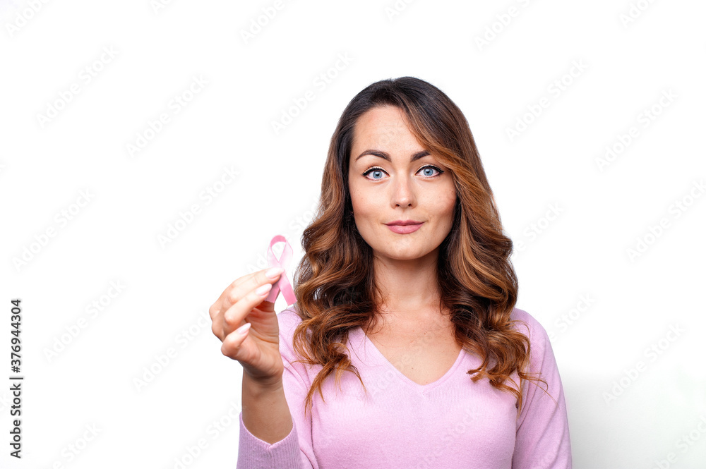 Woman in pink sweater with pink ribbon supporting breast cancer awareness campaign Woman in pink sweater with pink ribbon supporting breast cancer awareness campaign