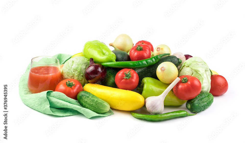 Composition of ripe fresh vegetables and a glass of vegetable juice on a white background with water drops. Food background. Side view. The concept of natural products, proper nutrition. Composition of ripe fresh vegetables and a glass of vegetable juice on a white background with water drops. Food background. Side view. The concept of natural products, proper nutrition.