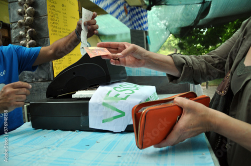 cash payment with cash register between seller and consumer