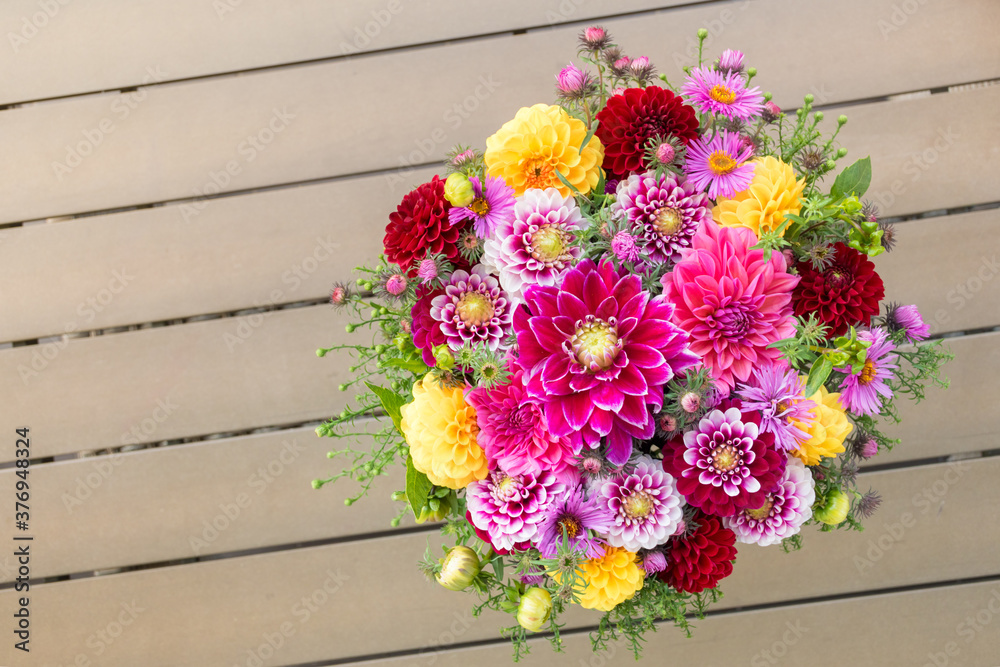 Elegant autumn bouquet or composition of flowers of dahlias, New England asters, red, purple and yellow shades or warm tones. Composition for Thanksgiving, anniversary, teacher's day, birthday