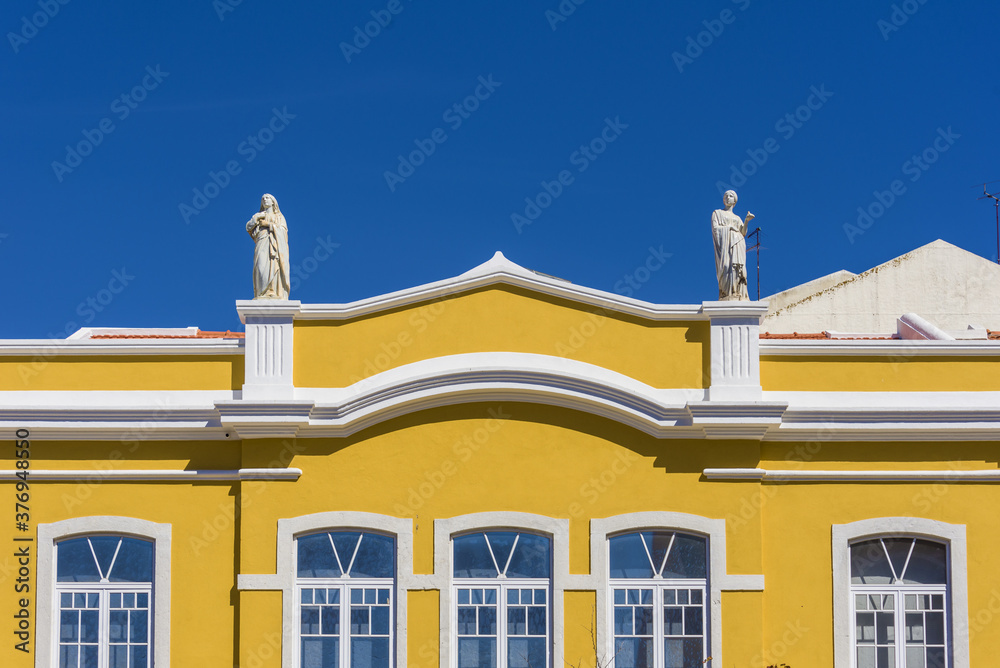 Obraz premium yellow building renovated with statues in Setubal