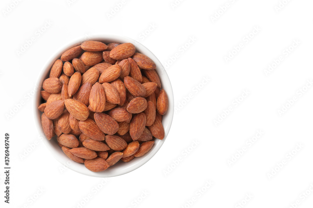 Almonds are in a white cup. Placed on a white floor. Food photography concept. Top view Almonds are in a white cup. Placed on a white floor. Food photography concept. Top view