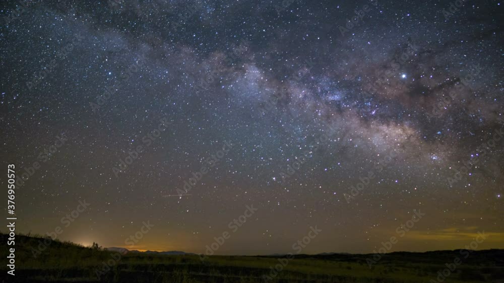 Astro timelapse of Milky Way galaxy rising over wildflowers in Mojave Desert in California Astro timelapse of Milky Way galaxy rising over wildflowers in Mojave Desert in California