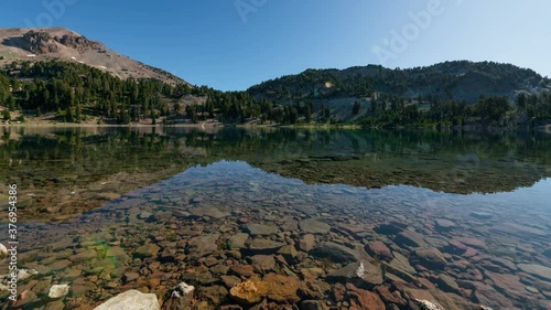  Timelapse tracking shot of reflective alpine lake at Lassen Volcanic National Park in California