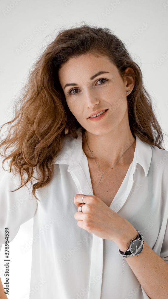 Young woman in white shirt on white background. Attractive girl in white clothes on a white background. Studio shot. Young woman in white shirt on white background. Attractive girl in white clothes on a white background. Studio shot.