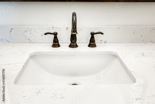 Canvastavla Sink in a domestic bathroom with an antique looking faucet and a marble counter