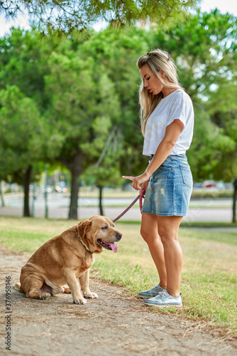 Woman training dog at the park
