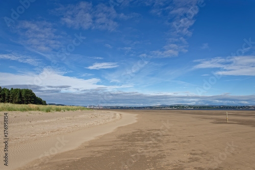 The wide expanse of sand at low tide at the Tentsmuir Nature Reserve on the Tay Estuary, with the City of Dundee in the background