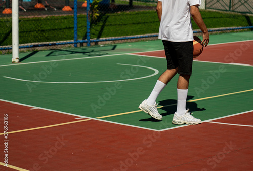 Young man on basketball court dribbling with ball © ErdalIslak