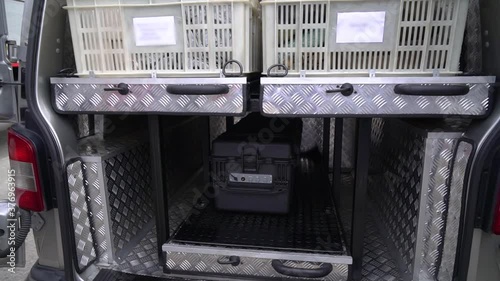 People in uniform load the vehicle. Special black protective box for transportation of dangerous radiation, chemical, and bacteriological cargo. Global Problem Dirty Air, Bad Ecology, Nature Pollution