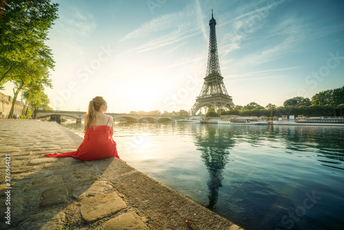 Young woman in red, looking to Eiffel tower, Paris © Iakov Kalinin
