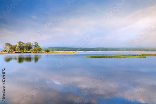 Idyllic summer landscape with clear sky and lake