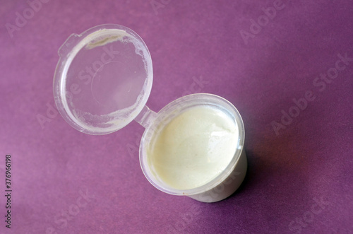 Opened jar of white cream for body and face care