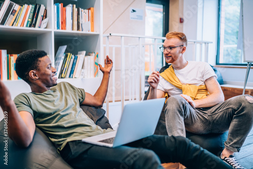 Black guy telling story to male colleague photo