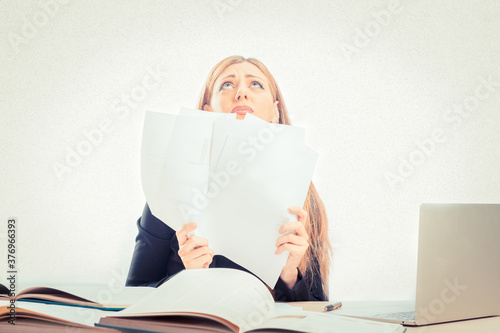 Blond woman feeling stress because of paper work at office