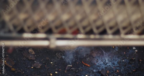 Flame roasting Hatch green chile. The fresh green peppers spin in slow motion charring the skins and cooking the vegetables. Green chile is a staple of New Mexican food, cuisine and cooking.  