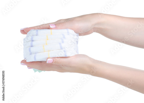 Stack baby diapers in hand on white background isolation