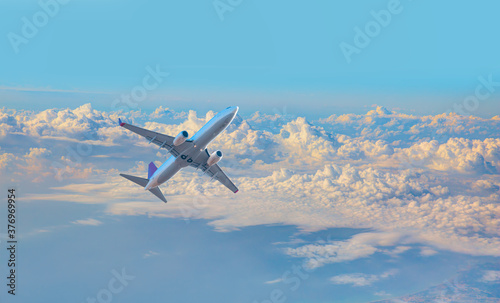 White passenger airplane in the clouds  - Travel by air transport
