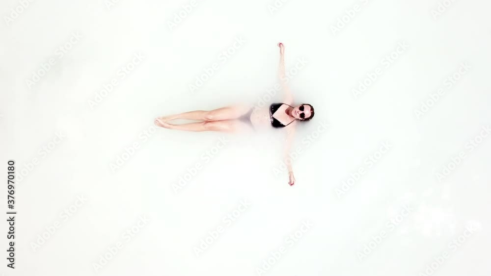 Woman floating in white water on resort Woman floating in white water on resort