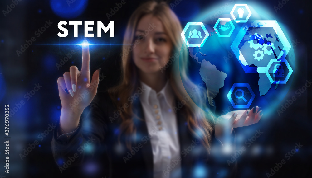 Business, Technology, Internet and network concept. Young businessman working on a virtual screen of the future and sees the inscription: STEM Business, Technology, Internet and network concept. Young businessman working on a virtual screen of the future and sees the inscription: STEM