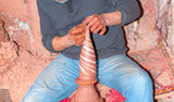 Man hands working on pottery wheel and making a pot.